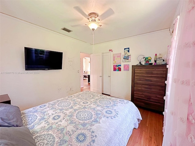 bedroom with hardwood / wood-style flooring and ceiling fan