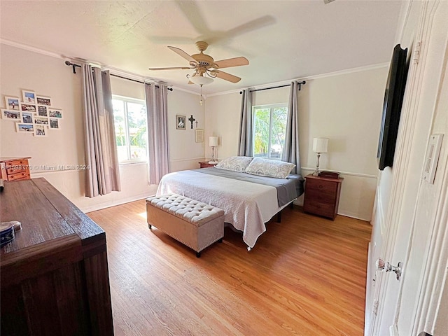 bedroom featuring multiple windows, light wood-type flooring, and ceiling fan