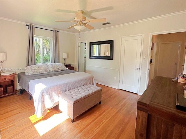 bedroom with ornamental molding, light hardwood / wood-style floors, and ceiling fan