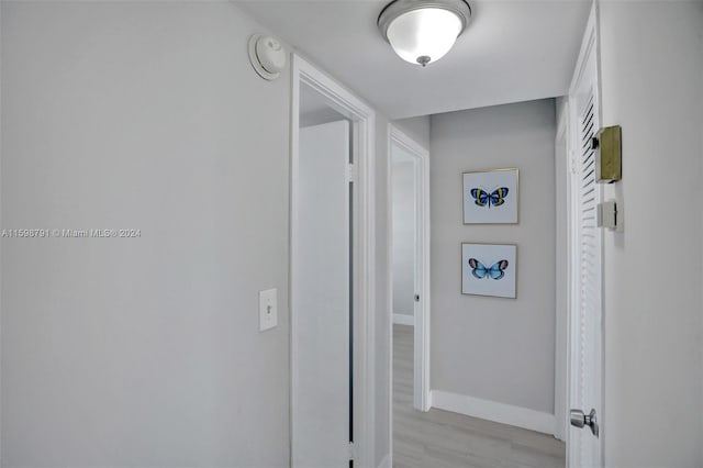 corridor with light wood-type flooring