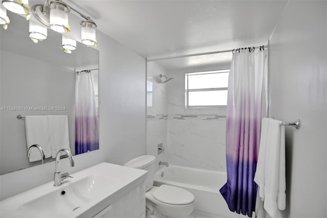 full bathroom with shower / bath combo with shower curtain, toilet, and vanity