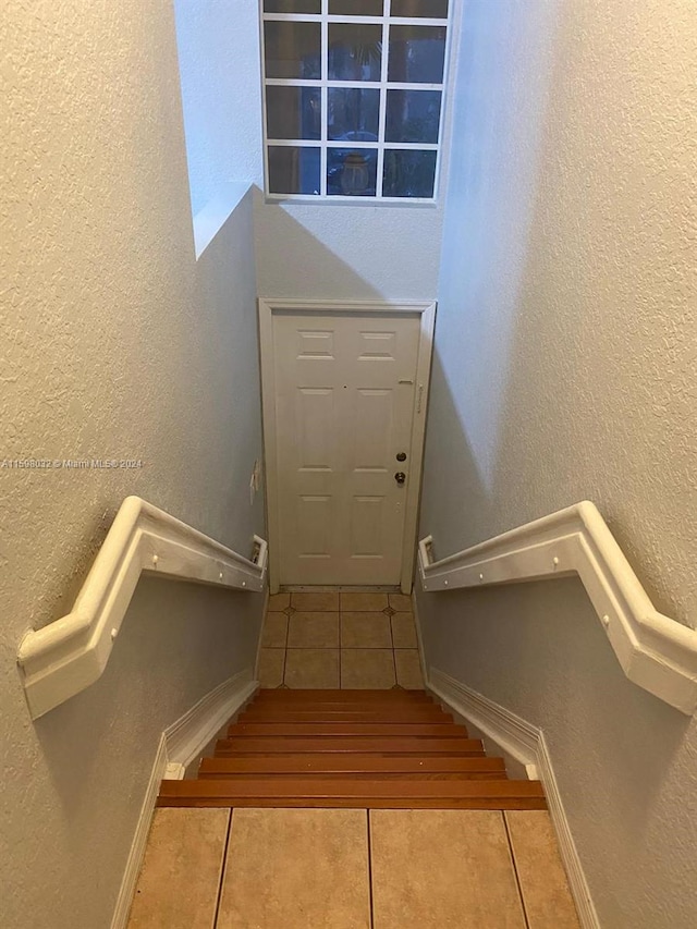 staircase with tile patterned flooring