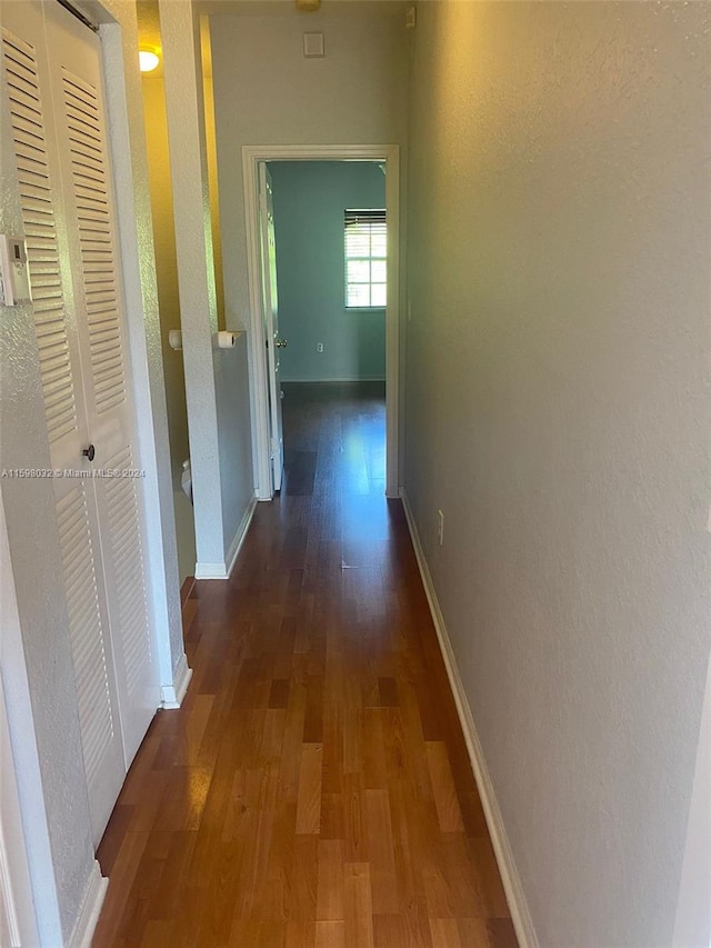 hall with dark hardwood / wood-style flooring