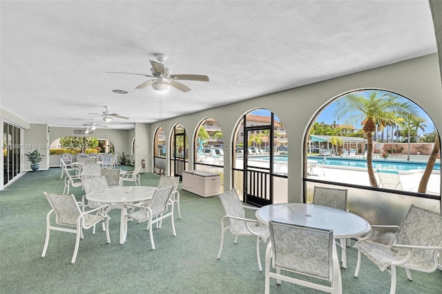 sunroom featuring ceiling fan