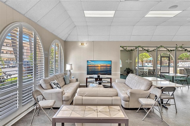 living room with a paneled ceiling