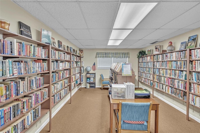 sitting room with a paneled ceiling and carpet