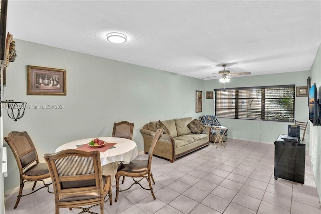 dining room with ceiling fan, light tile patterned floors, and a textured ceiling