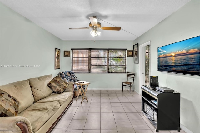 living room with light tile patterned floors, a textured ceiling, and ceiling fan