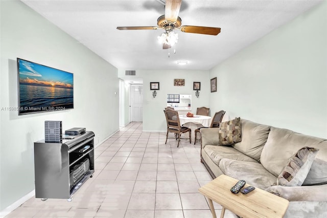 tiled living room with ceiling fan and a textured ceiling