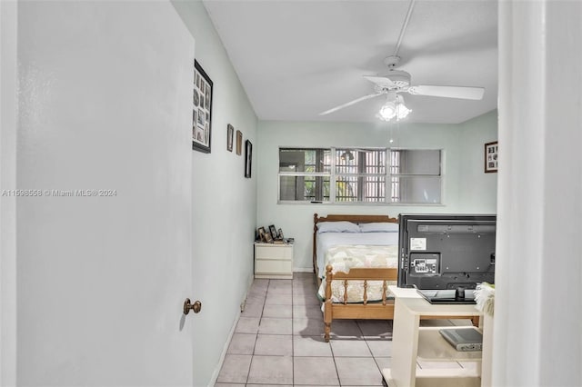 bedroom with ceiling fan and light tile patterned flooring