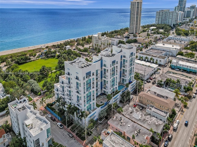 drone / aerial view featuring a beach view and a water view