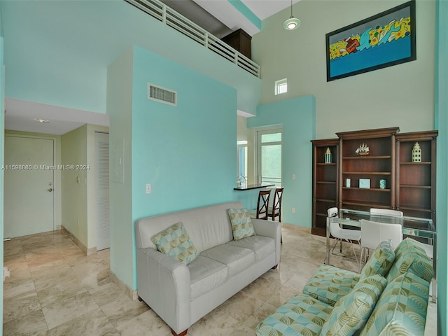 living room with a high ceiling