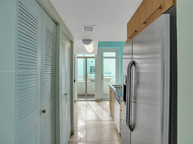 kitchen featuring stainless steel fridge