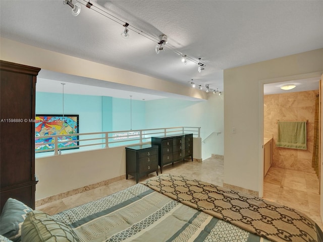 hall featuring a textured ceiling and light tile patterned flooring