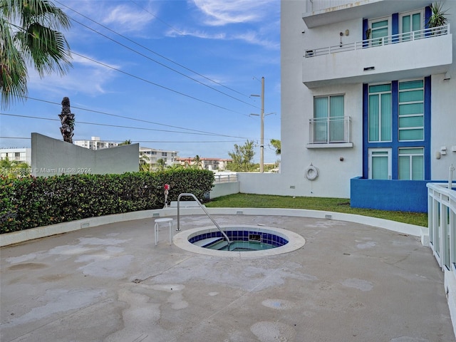 view of patio with an in ground hot tub