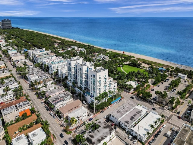 aerial view with a water view and a beach view