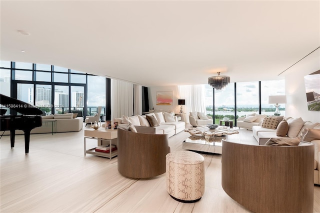 living room featuring floor to ceiling windows, light hardwood / wood-style flooring, and a chandelier