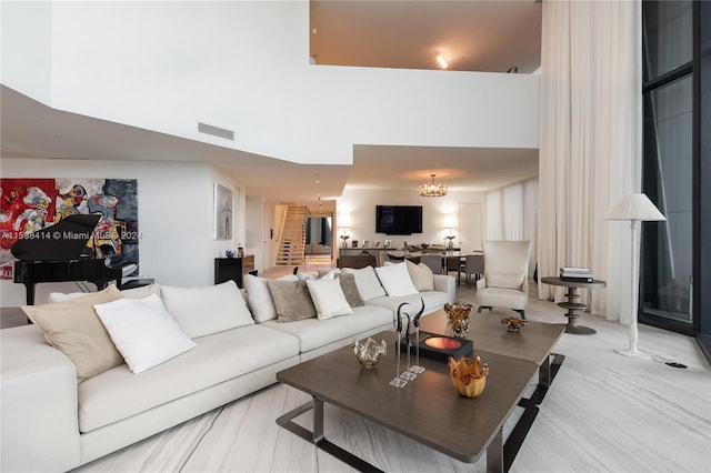 living room with a high ceiling and a chandelier