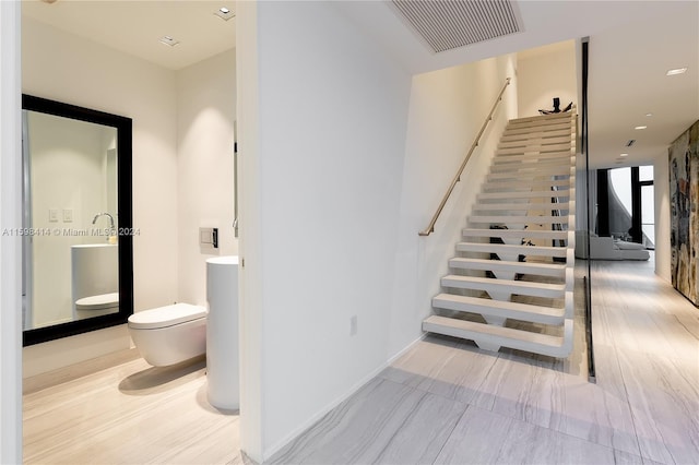 stairs with hardwood / wood-style flooring