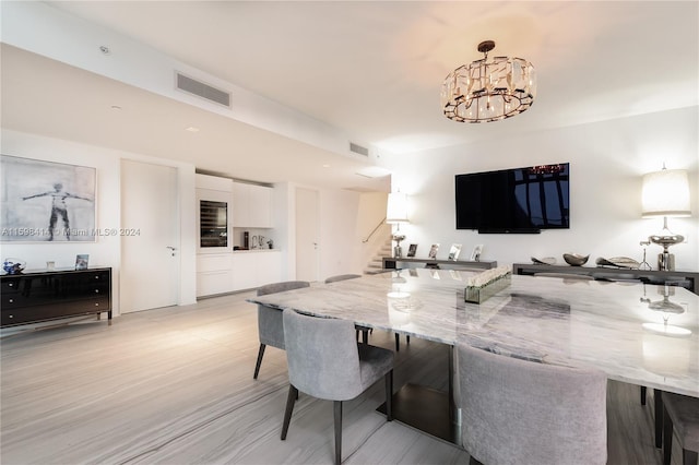 dining space featuring a chandelier and light hardwood / wood-style floors