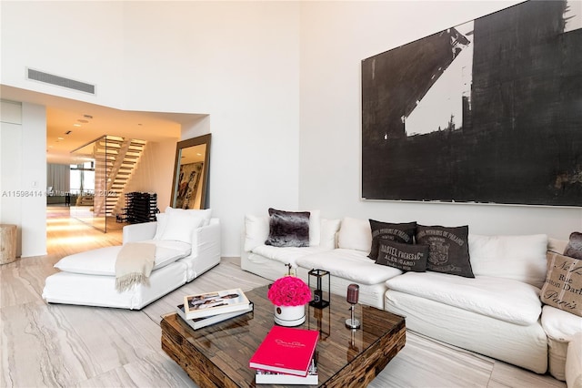 living room featuring hardwood / wood-style floors and a towering ceiling