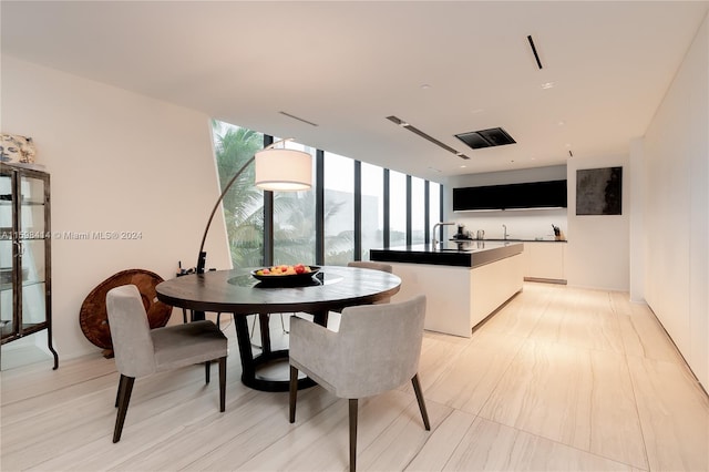 dining space featuring floor to ceiling windows