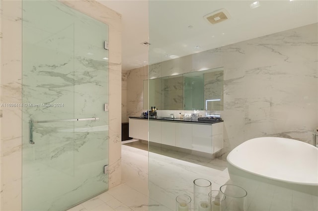 bathroom featuring vanity, tile walls, and plus walk in shower