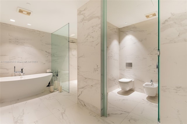 bathroom with a bidet, a tub to relax in, toilet, and tile walls