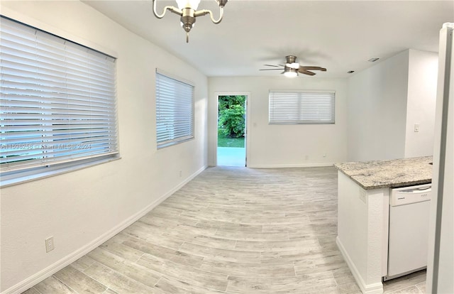 kitchen featuring ceiling fan with notable chandelier, white dishwasher, and light wood-type flooring