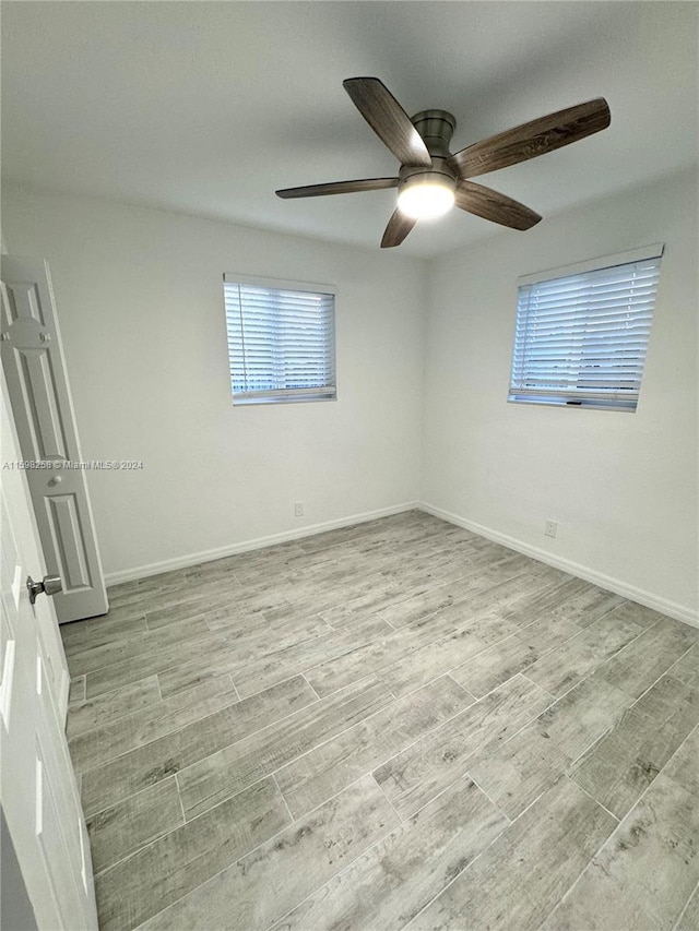 spare room featuring ceiling fan and light hardwood / wood-style floors