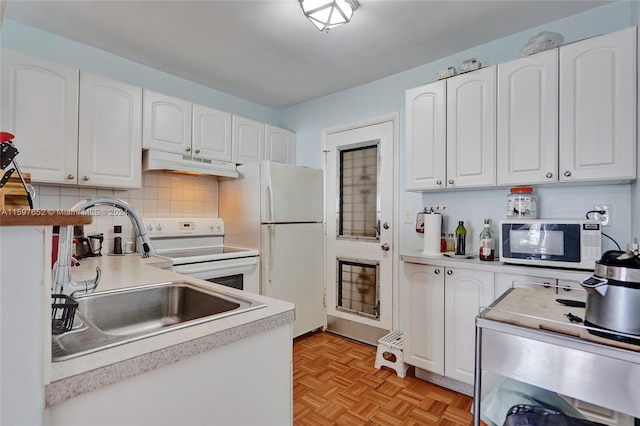 kitchen with white appliances, decorative backsplash, white cabinets, light parquet floors, and sink