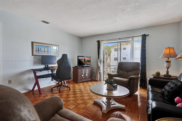 interior space featuring a textured ceiling and parquet floors