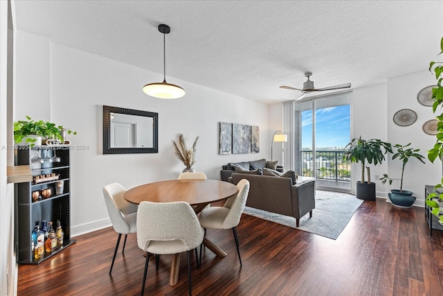 dining area with ceiling fan, floor to ceiling windows, dark hardwood / wood-style flooring, and a textured ceiling