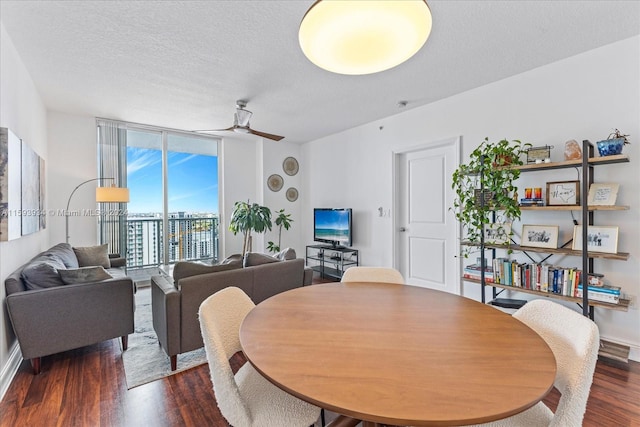 dining area featuring floor to ceiling windows, a textured ceiling, ceiling fan, and dark wood-type flooring