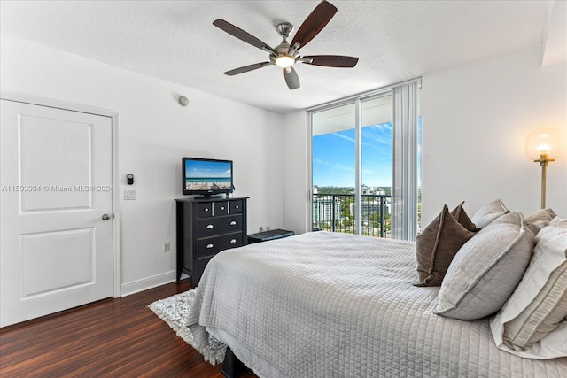 bedroom featuring dark hardwood / wood-style floors, ceiling fan, a textured ceiling, and access to outside