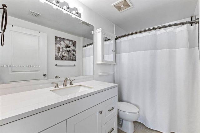 bathroom featuring tile patterned flooring, vanity, and toilet