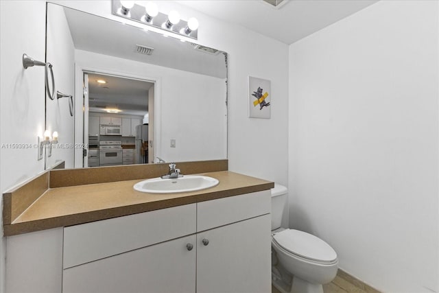 bathroom featuring vanity and toilet