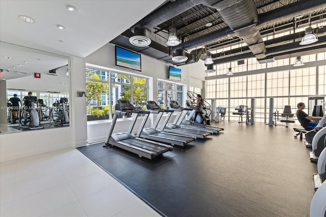 exercise room with a towering ceiling