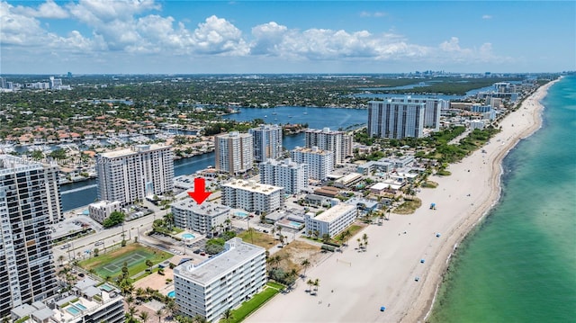 drone / aerial view featuring a water view and a beach view