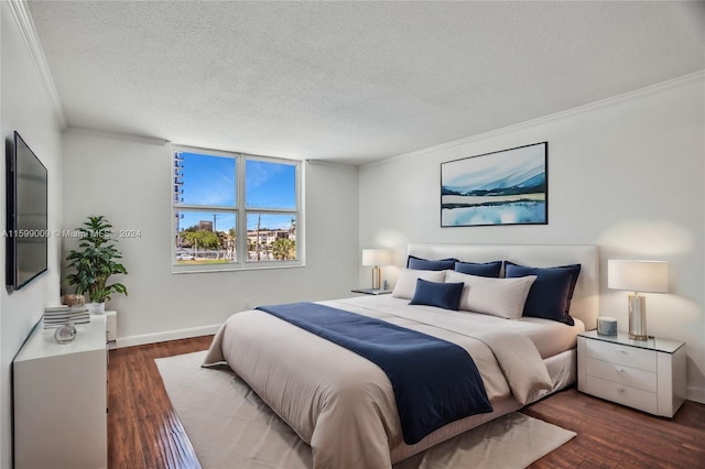 bedroom featuring dark hardwood / wood-style flooring, ornamental molding, and a textured ceiling