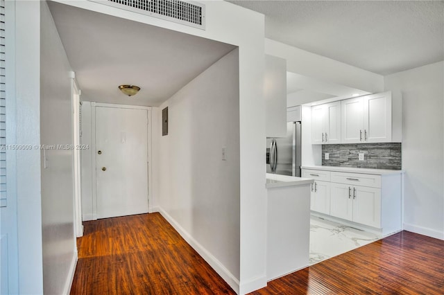 hallway with dark hardwood / wood-style flooring