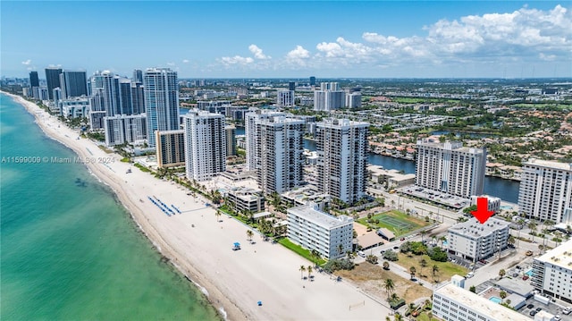 bird's eye view with a water view and a beach view