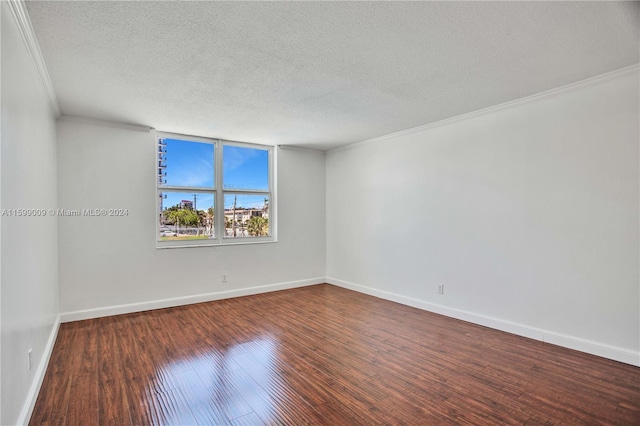 unfurnished room featuring dark hardwood / wood-style flooring, a textured ceiling, and crown molding