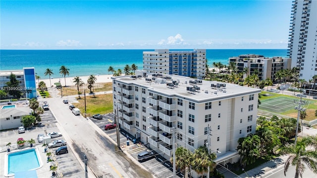 aerial view with a water view and a view of the beach