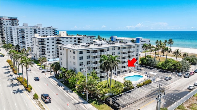 drone / aerial view with a water view and a beach view