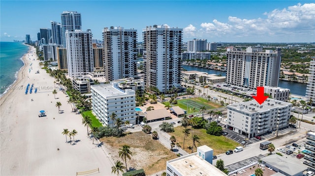 drone / aerial view featuring a beach view and a water view