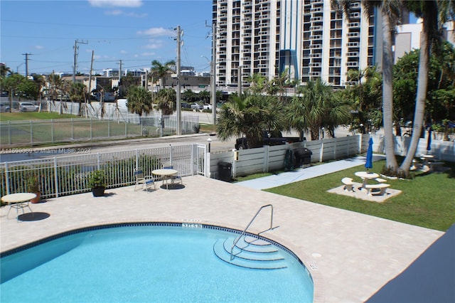 view of swimming pool with a patio