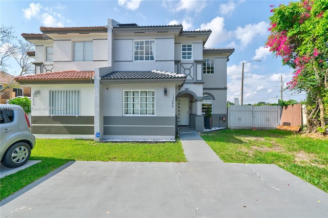 mediterranean / spanish-style house with a front yard