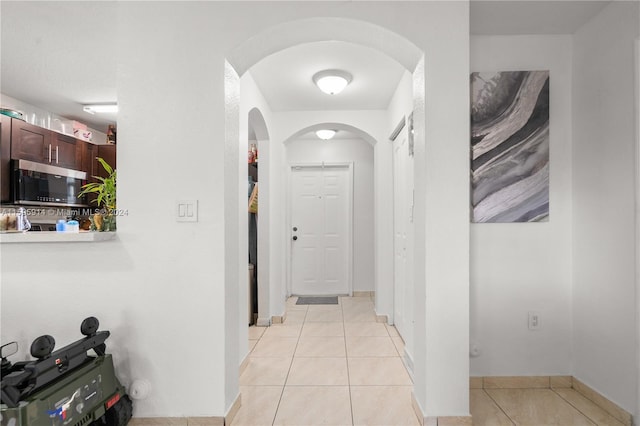 corridor with light tile patterned floors