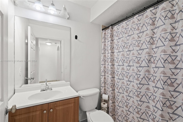 bathroom with vanity, toilet, and a shower with shower curtain